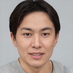 Joyful asian young-adult male with short  brown hair and brown eyes