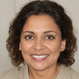 Joyful white adult female with medium  brown hair and brown eyes