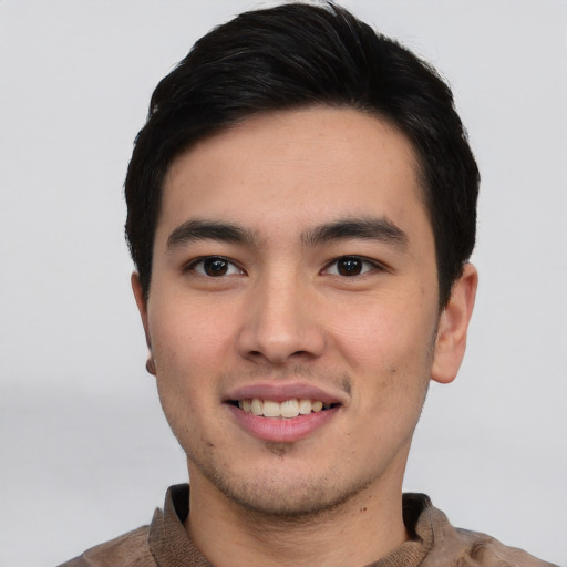 Joyful asian young-adult male with short  black hair and brown eyes