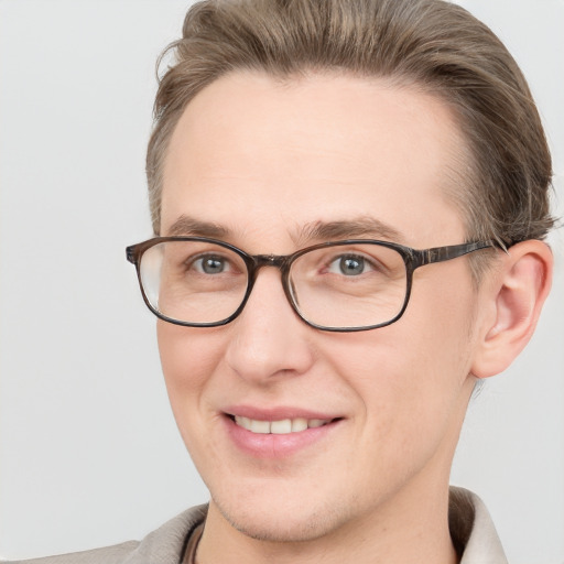 Joyful white adult male with short  brown hair and grey eyes