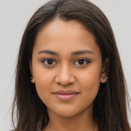 Joyful latino young-adult female with long  brown hair and brown eyes