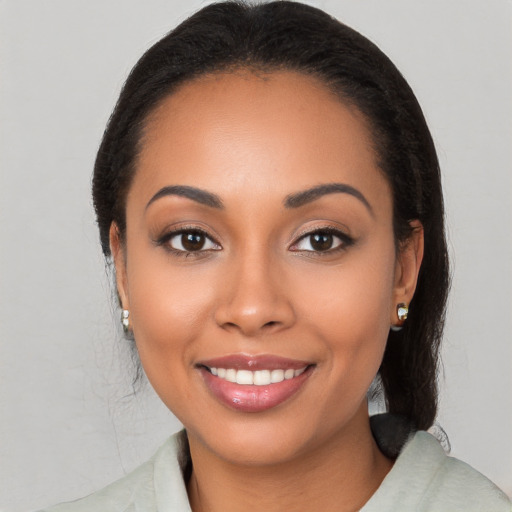 Joyful latino young-adult female with long  black hair and brown eyes