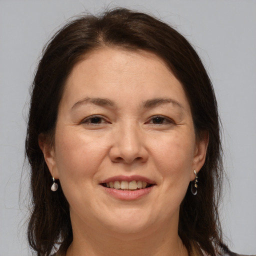 Joyful white adult female with medium  brown hair and brown eyes
