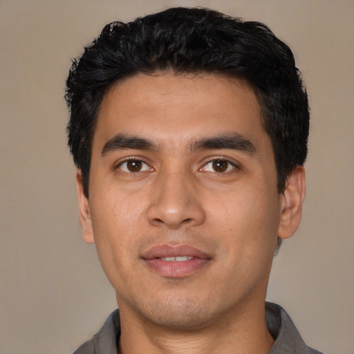Joyful asian young-adult male with short  black hair and brown eyes