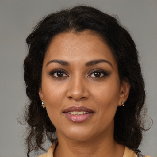 Joyful black young-adult female with medium  brown hair and brown eyes