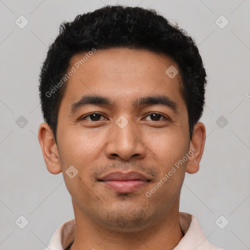 Joyful latino young-adult male with short  black hair and brown eyes