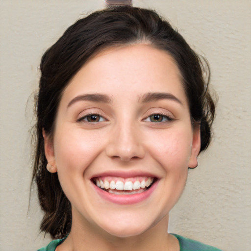 Joyful white young-adult female with medium  brown hair and brown eyes