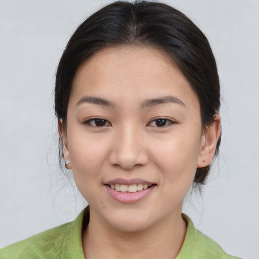 Joyful asian young-adult female with medium  brown hair and brown eyes