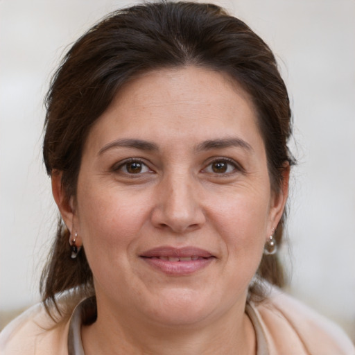 Joyful white adult female with medium  brown hair and brown eyes