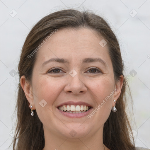 Joyful white adult female with long  brown hair and grey eyes