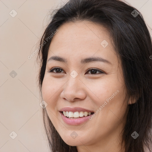 Joyful white young-adult female with long  brown hair and brown eyes