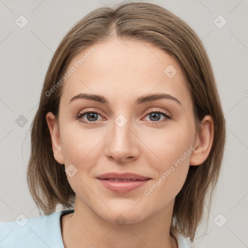 Joyful white young-adult female with medium  brown hair and grey eyes