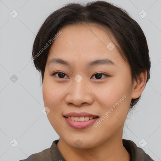 Joyful asian young-adult female with short  brown hair and brown eyes