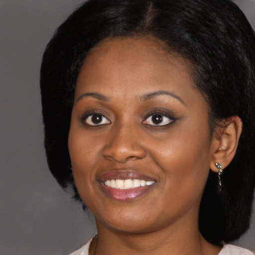 Joyful black young-adult female with medium  black hair and brown eyes
