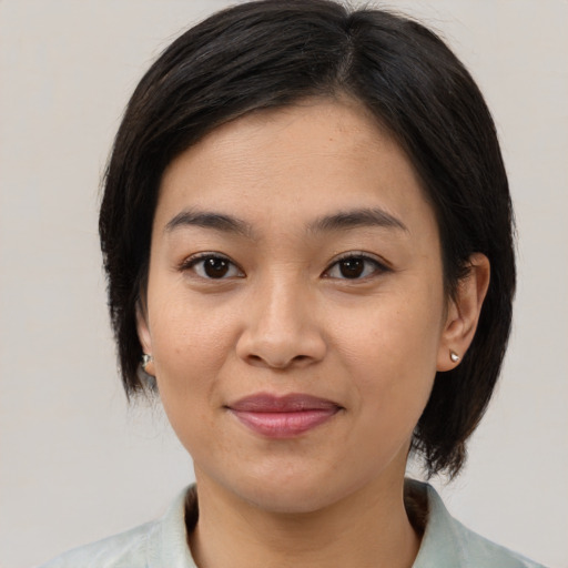 Joyful asian young-adult female with medium  brown hair and brown eyes