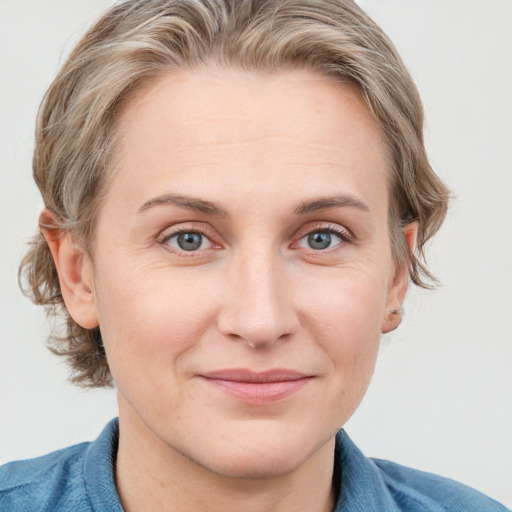 Joyful white young-adult female with medium  brown hair and blue eyes