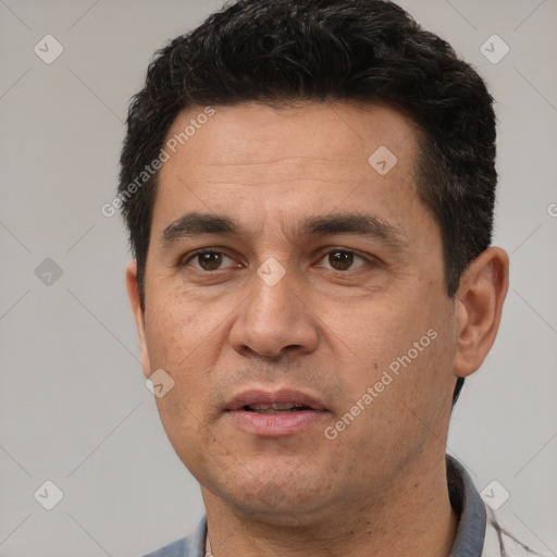 Joyful white adult male with short  black hair and brown eyes