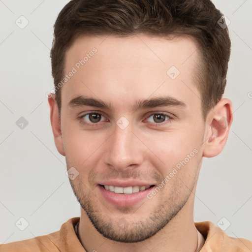 Joyful white young-adult male with short  brown hair and brown eyes