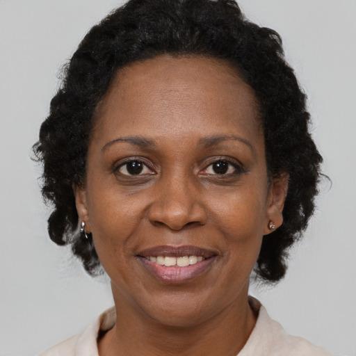 Joyful black adult female with short  brown hair and brown eyes