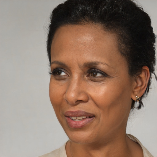 Joyful black adult female with short  brown hair and brown eyes