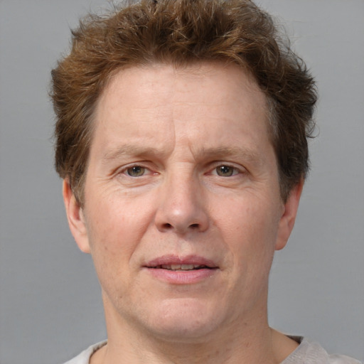 Joyful white adult male with short  brown hair and grey eyes