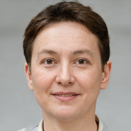 Joyful white adult female with short  brown hair and grey eyes