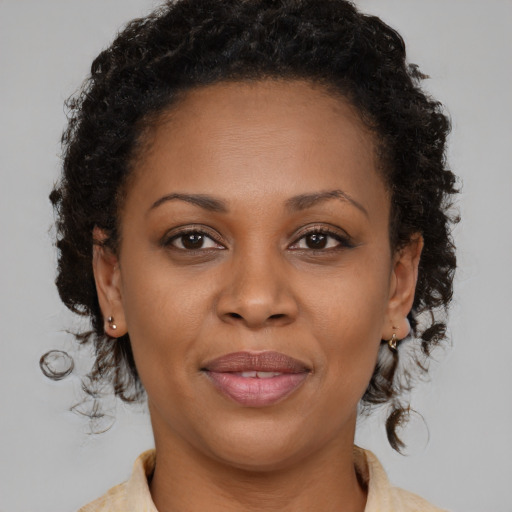 Joyful black young-adult female with medium  brown hair and brown eyes