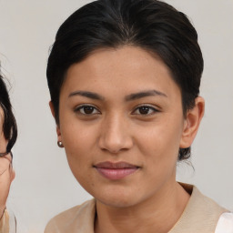 Joyful latino young-adult female with medium  brown hair and brown eyes