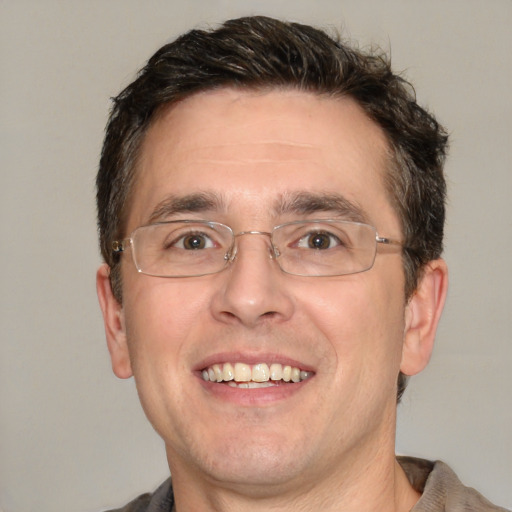 Joyful white adult male with short  brown hair and brown eyes