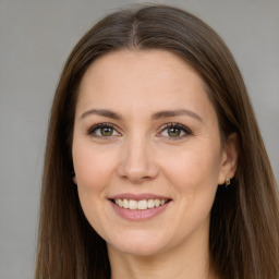 Joyful white adult female with long  brown hair and brown eyes