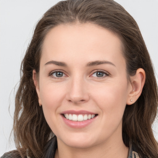 Joyful white young-adult female with long  brown hair and grey eyes