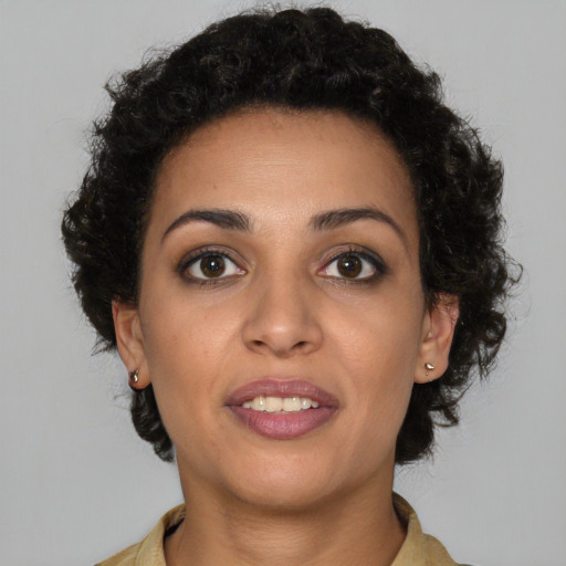 Joyful black young-adult female with short  brown hair and brown eyes