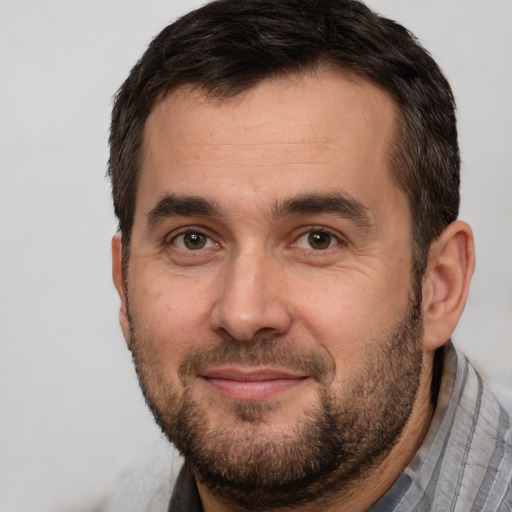 Joyful white adult male with short  brown hair and brown eyes