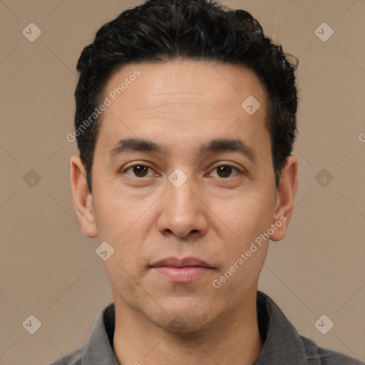 Joyful white adult male with short  black hair and brown eyes