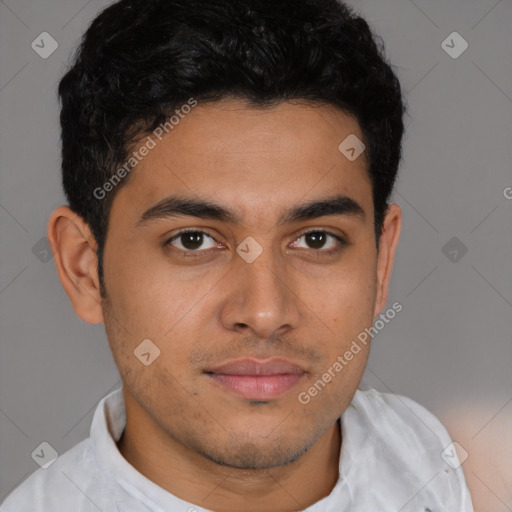 Joyful latino young-adult male with short  brown hair and brown eyes