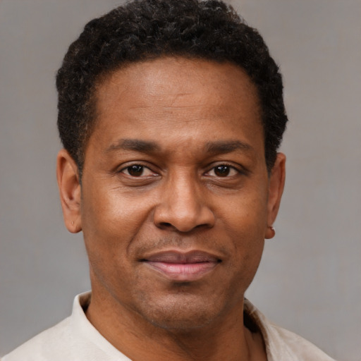 Joyful latino adult male with short  brown hair and brown eyes