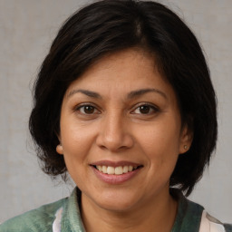 Joyful white adult female with medium  brown hair and brown eyes