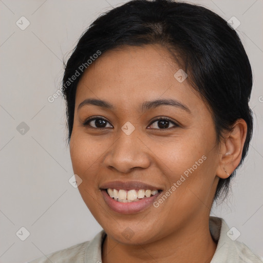 Joyful latino young-adult female with medium  brown hair and brown eyes