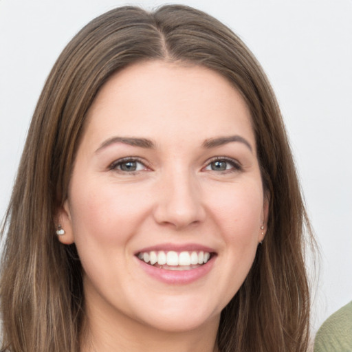 Joyful white young-adult female with long  brown hair and grey eyes