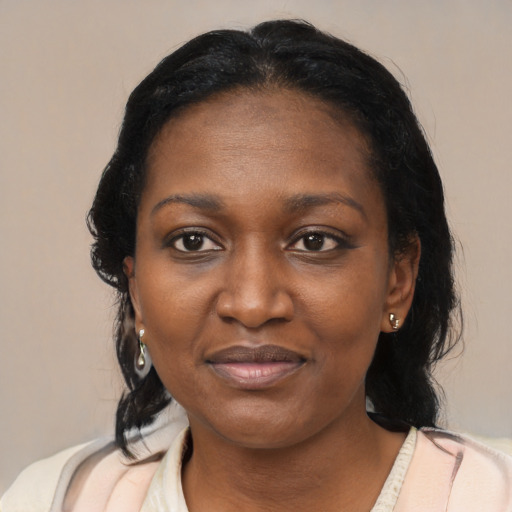 Joyful black adult female with medium  black hair and brown eyes