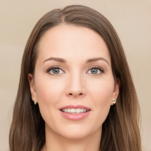 Joyful white young-adult female with long  brown hair and green eyes