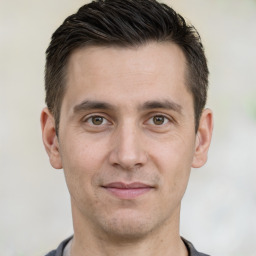 Joyful white adult male with short  brown hair and brown eyes