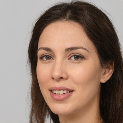 Joyful white young-adult female with long  brown hair and brown eyes