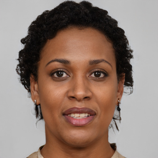 Joyful black young-adult female with short  brown hair and brown eyes