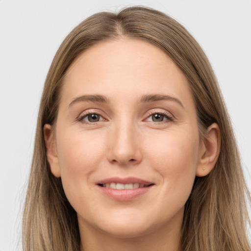 Joyful white young-adult female with long  brown hair and grey eyes