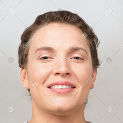 Joyful white adult female with short  brown hair and grey eyes