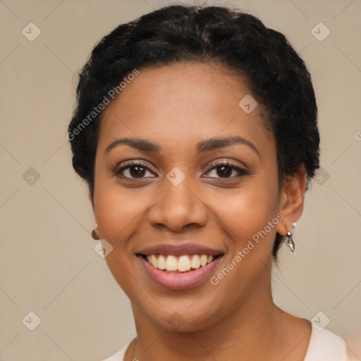 Joyful black young-adult female with short  black hair and brown eyes