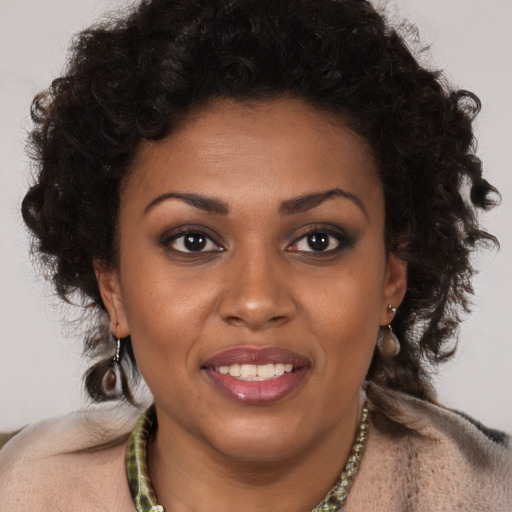 Joyful black young-adult female with medium  brown hair and brown eyes