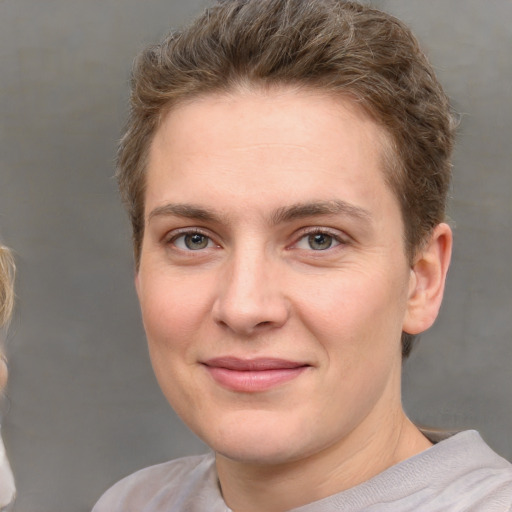 Joyful white young-adult female with short  brown hair and grey eyes