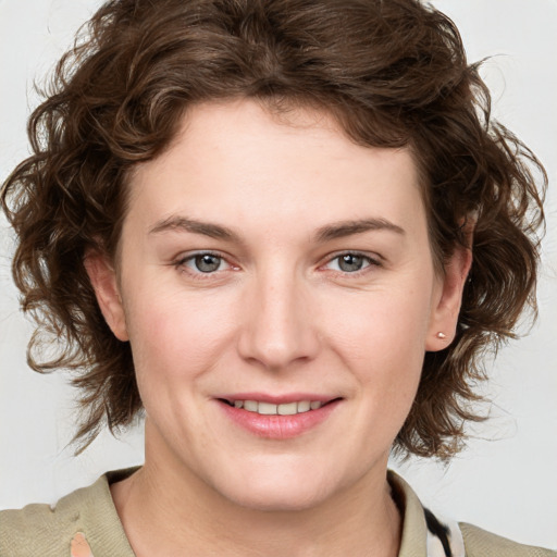 Joyful white young-adult female with medium  brown hair and blue eyes